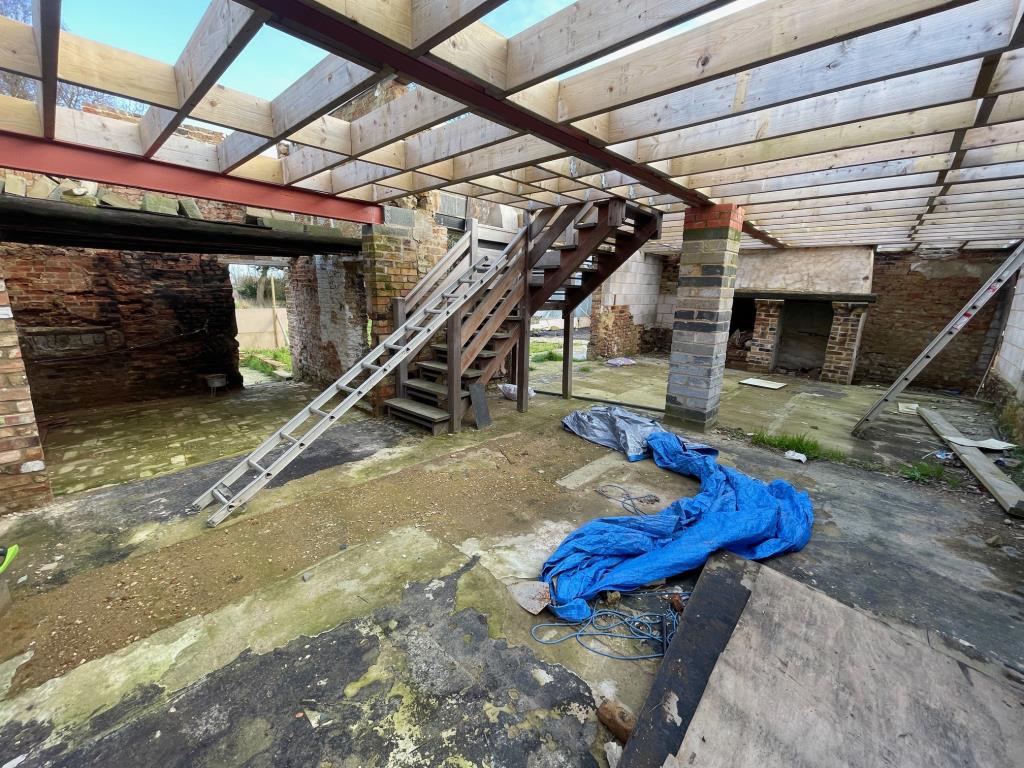 Lot: 101 - COTTAGE RENOVATION PROJECT WITH PLANNING IN VILLAGE LOCATION - Open plan ground floor and exposed ceiling and brickwork